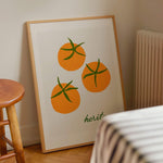orange tomato art print and vintage green font in pine wood frame in kitchen