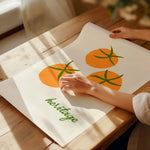 orange tomato art print on cotton paper rolled on vintage kitchen table